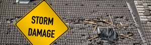 roof with damage and yellow sign saying storm damage