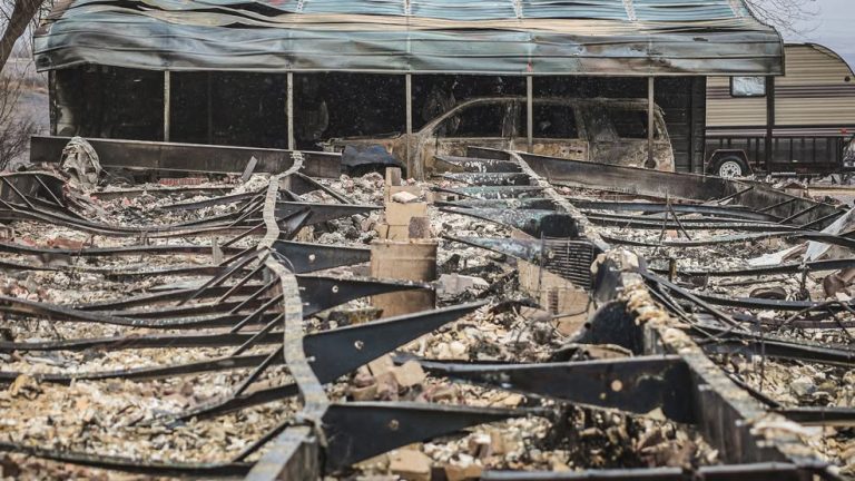 damage to a house and vehicle after a wildfire